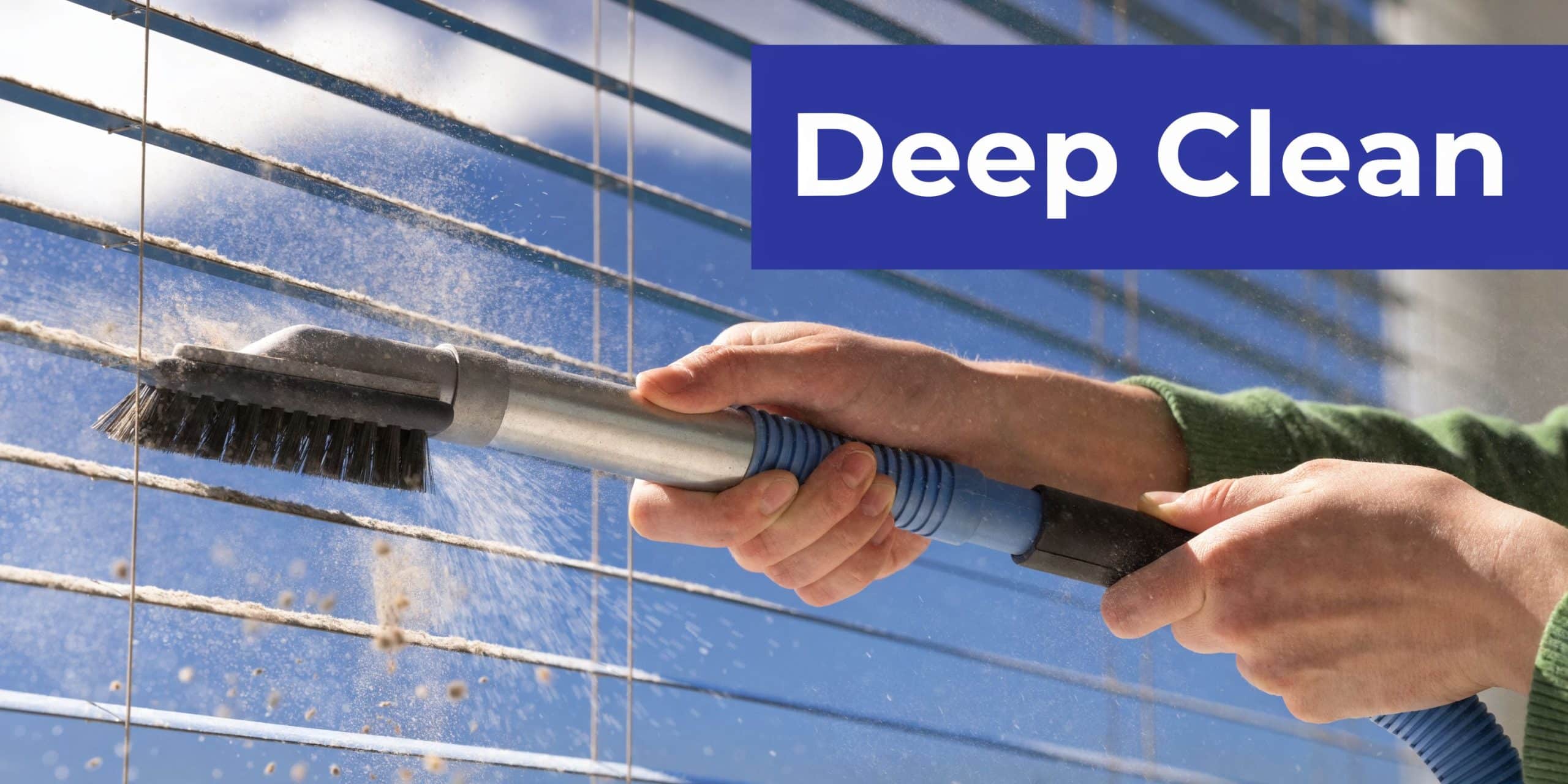 A person using a vacuum cleaner attachment to remove dust from blinds in a home cleaning process.