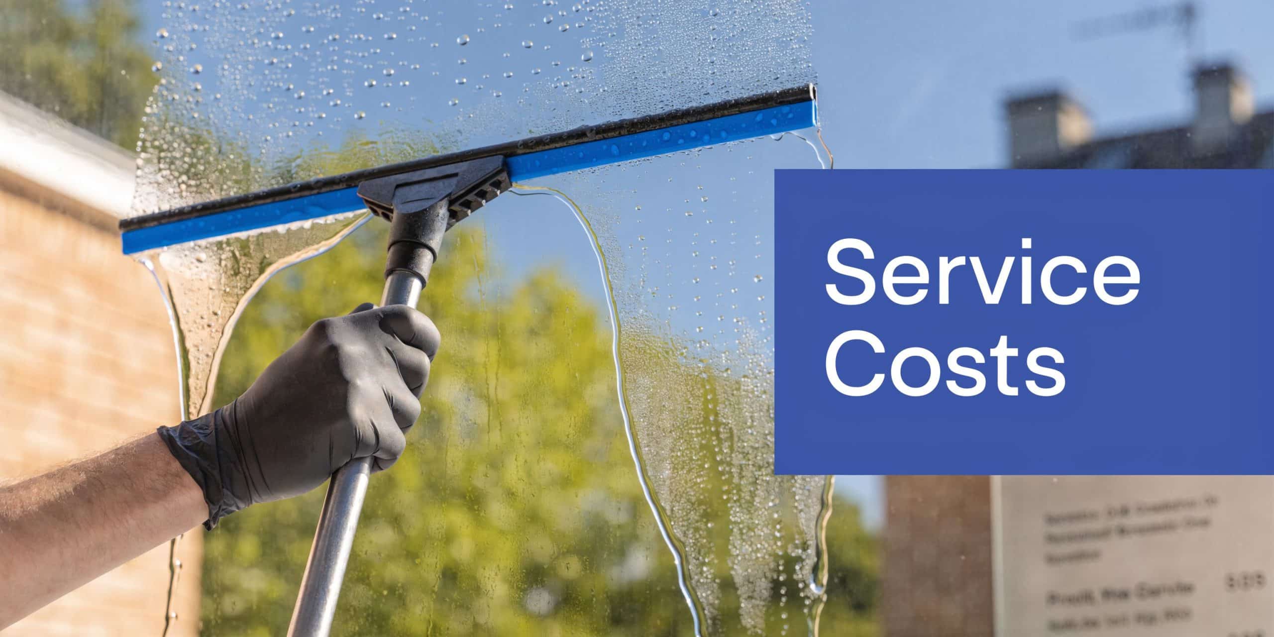 A professional cleaner uses a squeegee to clean a glass window, representing window cleaning service costs.