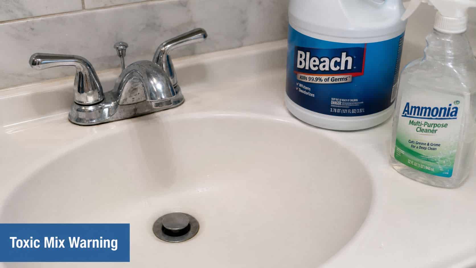 A bottle of bleach and ammonia sitting next to a bathroom sink, posing a dangerous chemical hazard.